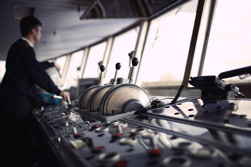 Officer at the controls on a ship's bridge